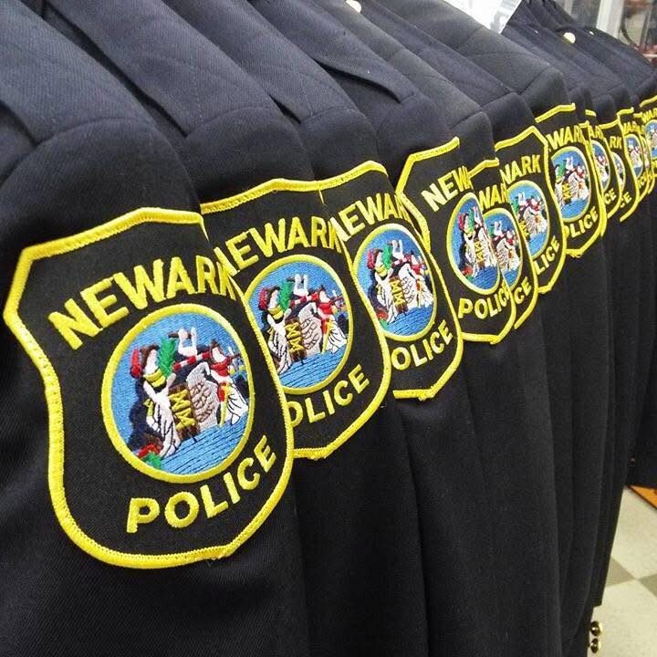 Row of Newark Police Class A uniform jackets with department shoulder patches