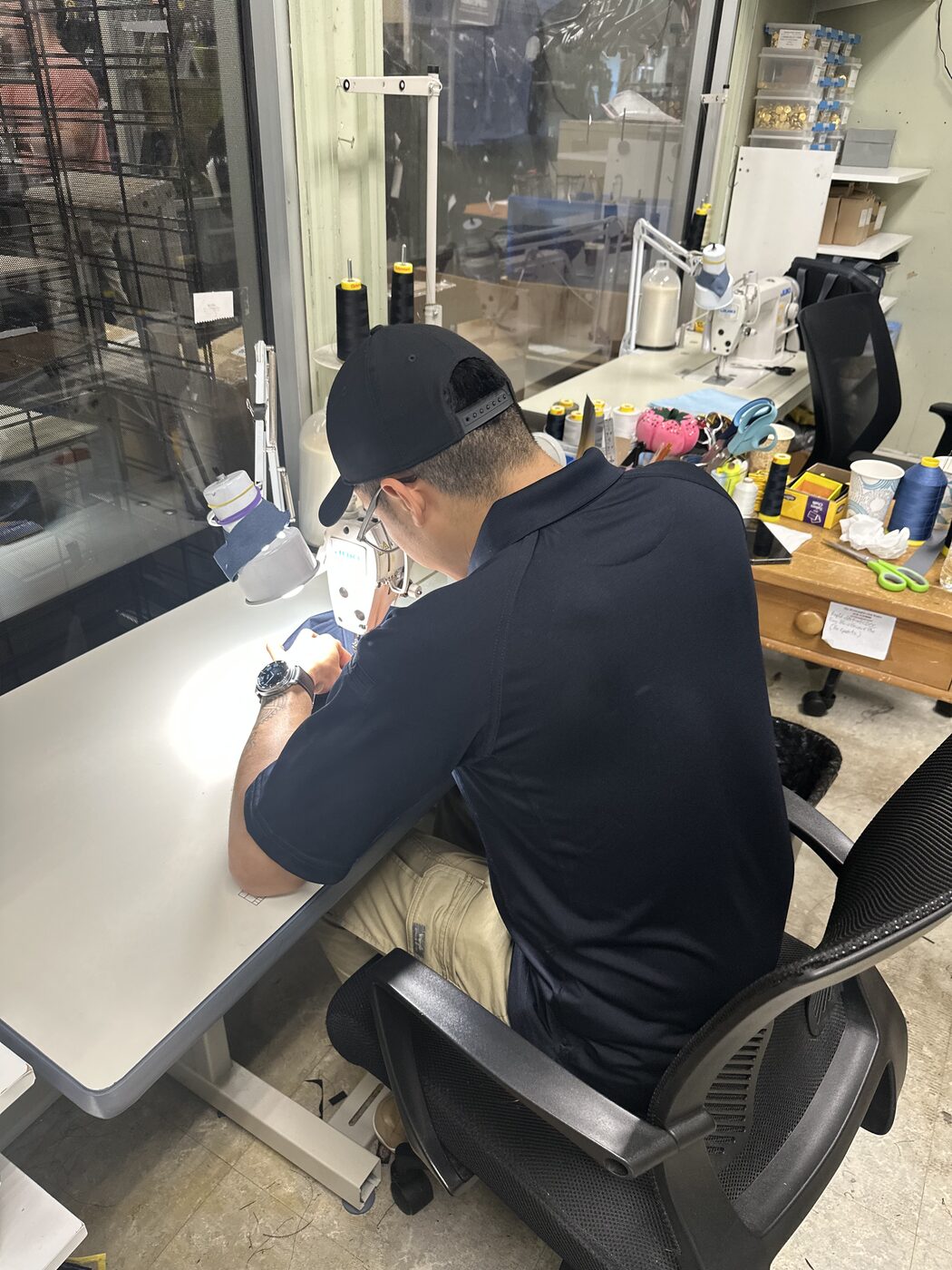 Atlantic Uniform sewing specialist working at a machine in the on-site Belleville workshop