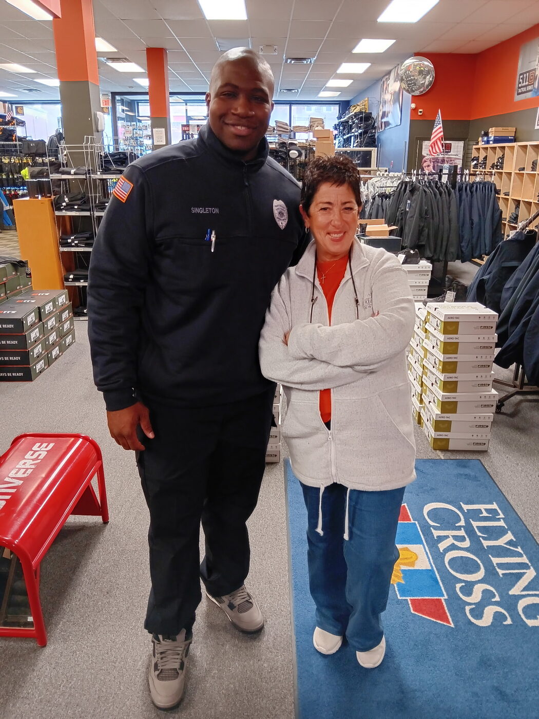Atlantic Uniform staff member assisting a customer on the Belleville sales floor